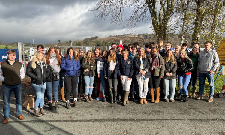 A crowd of students form the Harper Cymru Society pose for a photo on a trip to the royal welsh winter fair.